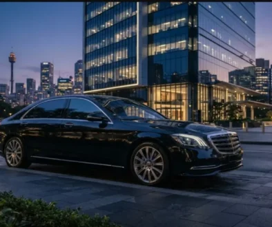 Luxury executive sedan parked outside a Sydney corporate building at twilight