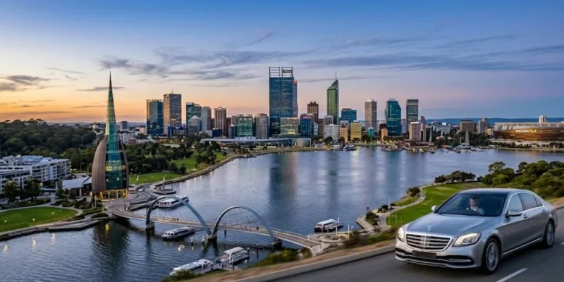 Perth skyline at sunset with luxury chauffeur car driving past Elizabeth Quay and Swan River